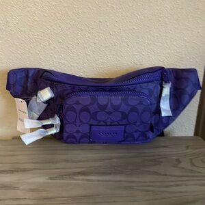 New with tags coach purple track belt bag .
